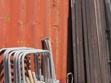 a pile of junk in front of a red dumpster