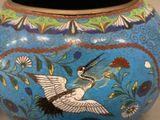 a blue vase with a bird painted on it