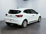 the rear end of a white car parked in a garage
