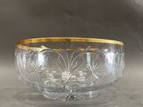 a glass bowl with a gold rim sitting on a table