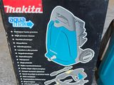 a box that has a blue vacuum on the floor