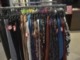 a lot of clothes hanging on a rack in a store