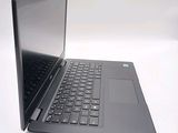 a laptop that is open on a white surface