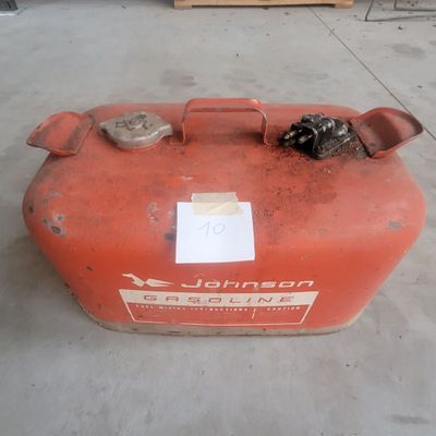 a red gas can sitting on the floor in a warehouse