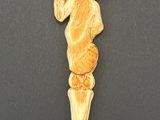 carved ivory figurine of a man with a hat on his head