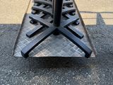 a black umbrella on a metal stand on the street