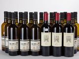several bottles of wine are lined up in a row on a table