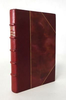 an old red book with a gold binding on a white background