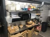 a kitchen with a lot of food on the shelves
