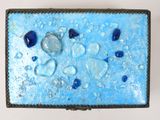 a picture of a blue and white box with blue beads