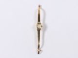 an image of a gold watch on a white surface with a white background