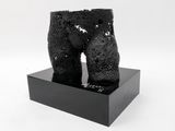 black sculpture of a man ' s torso on a black base