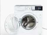 une photo d'une machine à laver dont la porte est ouverte