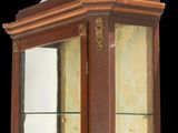 a glass display case with a clock on top of it