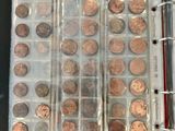 an open book with a bunch of coins in it on a table