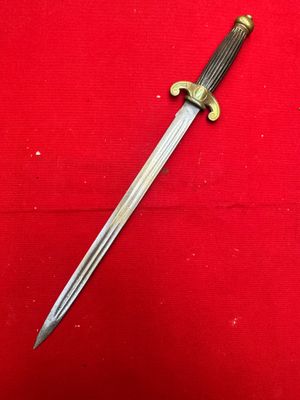 a close up of a knife on a red surface