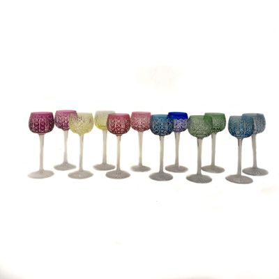 six wine glasses lined up in a row on a table