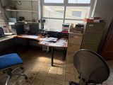 a desk with a chair and a computer on it in a room