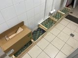 a box of bottles sitting on the floor next to a box of bottles