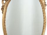 une image d'un miroir encadré d'or sur un mur blanc