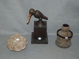 a bird that is sitting on a table next to some vases