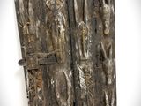 an old wooden door with carvings on it in a white room