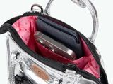 a silver purse with a cell phone inside of it