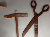 two pairs of scissors and a hammer on a table