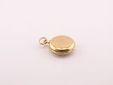 a gold locke charm with a gold disc on a white background