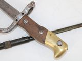 a knife that is laying on a table next to a pair of scissors