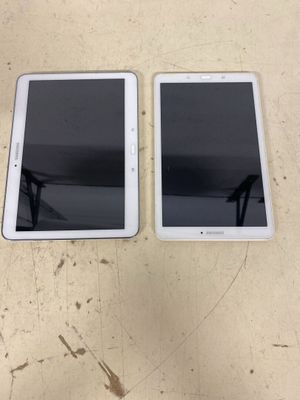 two ipads are sitting side by side on a table