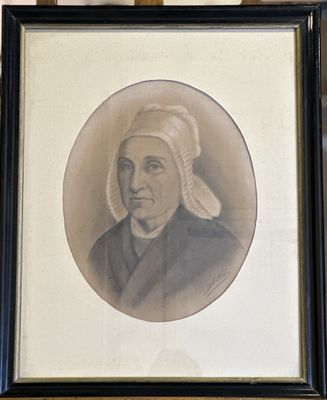 framed portrait of a woman with a turban on her head in a black frame