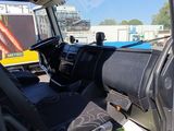 a view of the inside of a truck from the driver ' s seat