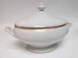a white bowl with a gold trim and a lid