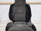 a close up of a car seat on a wooden floor