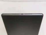 the back of a laptop computer sitting on top of a white surface