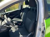 a green car with black seats and a black steering wheel