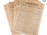 several newspapers are stacked on top of each other on a white surface