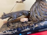 a statue of a woman and a dog on a table