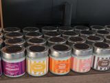 many candles that are sitting on a shelf