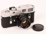 a black and white photo of a camera and a lens