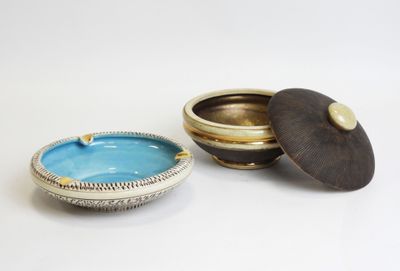 a small bowl with a lid sitting next to a smaller bowl