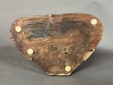 a small wooden heart shaped object on a table
