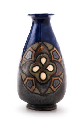 a blue vase with a design on it on a white background