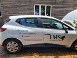 a car that is parked in front of a building