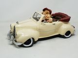a toy car with a teddy bear sitting in it