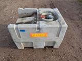 a cement container with a valve on it on a dirt road