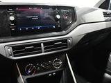 the interior of a car with a touch screen and steering controls