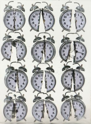 many clocks that are arranged in a row on the table