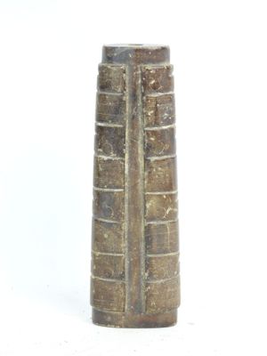 a brown vase that is sitting on a white surface
